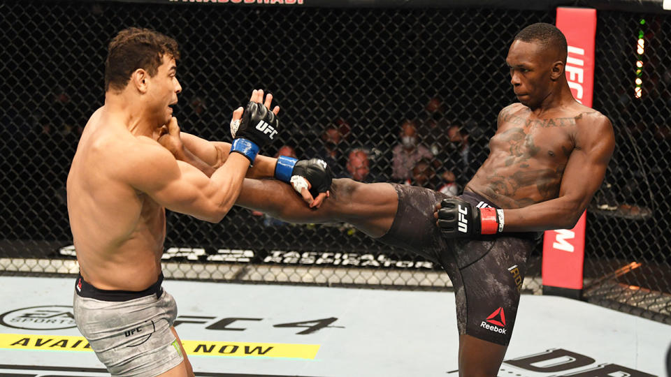 Israel Adesanya is seen here kicking Paulo Costa in their UFC 253 middleweight title fight.