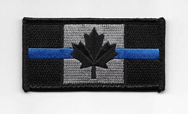 Saint John police tweeted that it has spoken with its officers following photos being posted on social media of officers at a protest wearing patches with a thin blue line going through the Canadian flag.  (amazon - image credit)