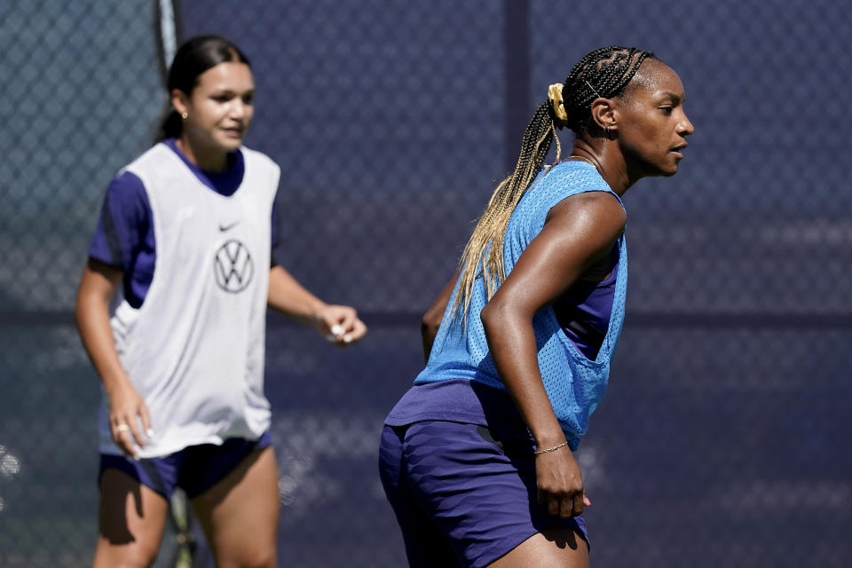 U.S. national team players Crystal Dunn, right, and Sophie Smith practice for a match against Nigeria Tuesday, Aug. 30, 2022, in Riverside, Mo. Women’s soccer in the United States has struggled with diversity, starting with a pay-to-play model that can exclude talented kids from communities of color. (AP Photo/Charlie Riedel)