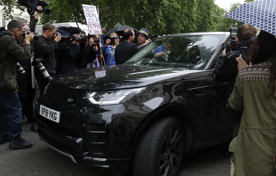 Protestors and the media surround the car as Britain's Conservative Party lawmaker Boris Johnson leaves after launching his leadership campaign, in London, Wednesday June 12, 2019. Boris Johnson solidified his front-runner status in the race to become Britain's next prime minister on Tuesday, gaining backing from leading pro-Brexit lawmakers. (AP Photo/Kirsty Wigglesworth)