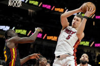 Miami Heat forward Nikola Jovic (5) works for the rebound against Atlanta Hawks guard Dejounte Murray (5) during the first half of an NBA basketball game, Tuesday, April 9, 2024, in Atlanta. (AP Photo/Mike Stewart)
