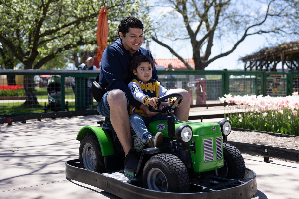 Visitors ride Tractor Time, the newest attraction at Nelis’ Dutch Village on April 30.