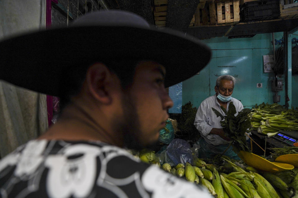 A man shops for vegetables at a market in Mexico City, Tuesday, Aug. 9, 2022. Mexico's annual inflation rate rose to 8.15% in July, driven largely by the rising price of food, according to government data released Tuesday. (AP Photo/Fernando Llano)