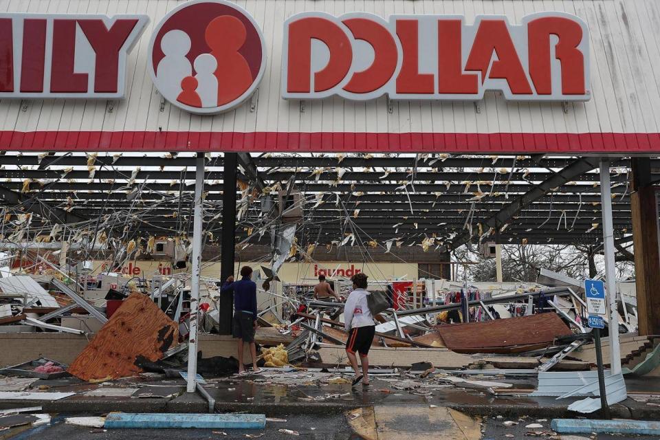 People look on at a damaged store in Panama City (Getty)