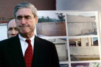 <p>FBI Director Robert Mueller grimaces while listening to Los Angeles Mayor Antonio Villaraigosa speaking of the death of Cheryl Green, during a news conference announcing anti-gang measures, Thursday Jan. 18, 2007 in Wilmington, Calif. Authorities announced Thursday an offensive against the Hispanic gang allegedly behind the racially charged shooting death of Cheryl Greenl, the first part of what they said will be a major crackdown on street gangs this year. In the background photos of the 204th Street gang graffiti. (Photo: Damian Dovarganes/AP) </p>