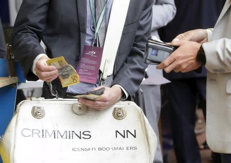 Bets being placed with bookmakers during the Melbourne Cup race day at Flemington Racecourse in Melbourne, Victoria November 3, 2015. REUTERS/Hamish Blair