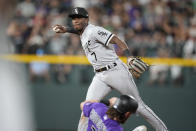 Chicago White Sox shortstop Tim Anderson, back, forces out Colorado Rockies' Brendan Rodgers at second base on the front end of a double play hit into by Ryan McMahon to end the sixth inning of a baseball game Tuesday, July 26, 2022, in Denver. (AP Photo/David Zalubowski)