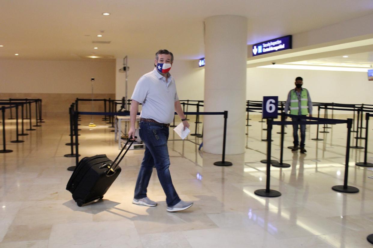 <p>U.S. Senator Ted Cruz (R-TX) carries his luggage at the Cancun International Airport before boarding his plane back to the U.S., in Cancun, Mexico February 18, 2021. </p> (Reuters)