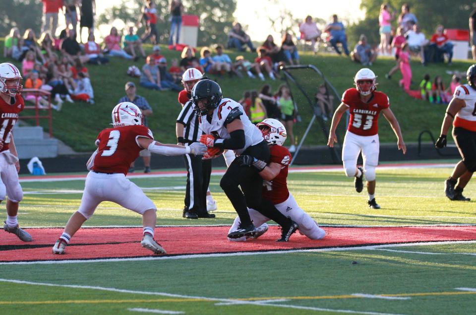 Gibson Cary fights for yards after hauling in a pass against Coldwater on Friday.