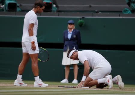 Tennis - Wimbledon - All England Lawn Tennis and Croquet Club, London, Britain - July 11, 2018 Argentina's Juan Martin Del Potro with Spain's Rafael Nadal after falling during their quarter final match REUTERS/Andrew Couldridge