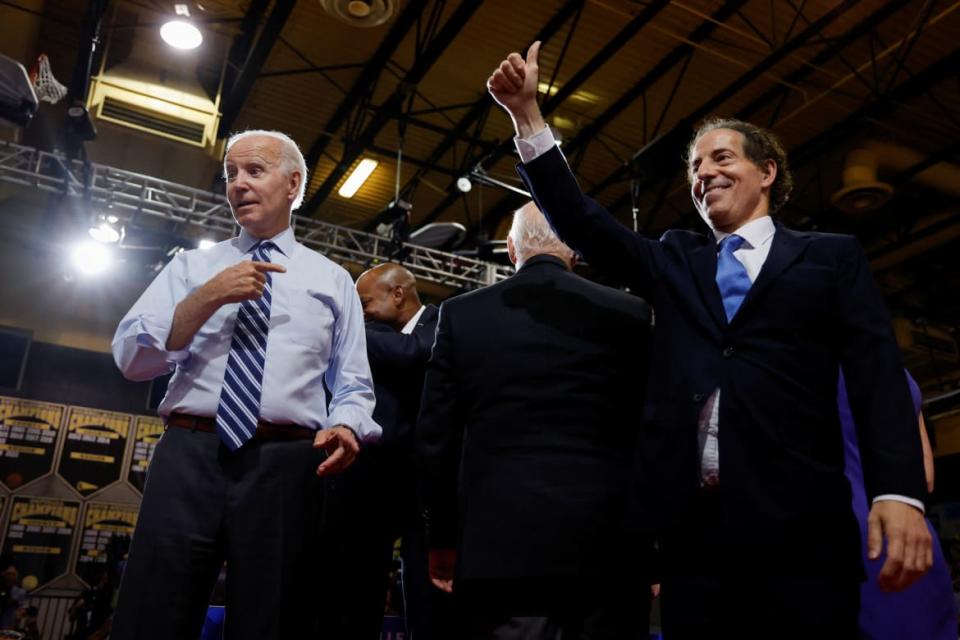 Joe Biden points at Jamie Raskin, who is smiling and giving a thumbs up gesture