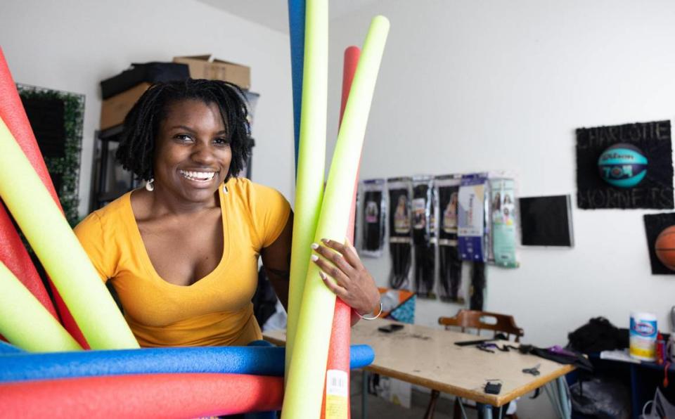 Nadia Meadows holds on to pool noodles that she plans to use for an upcoming art project.