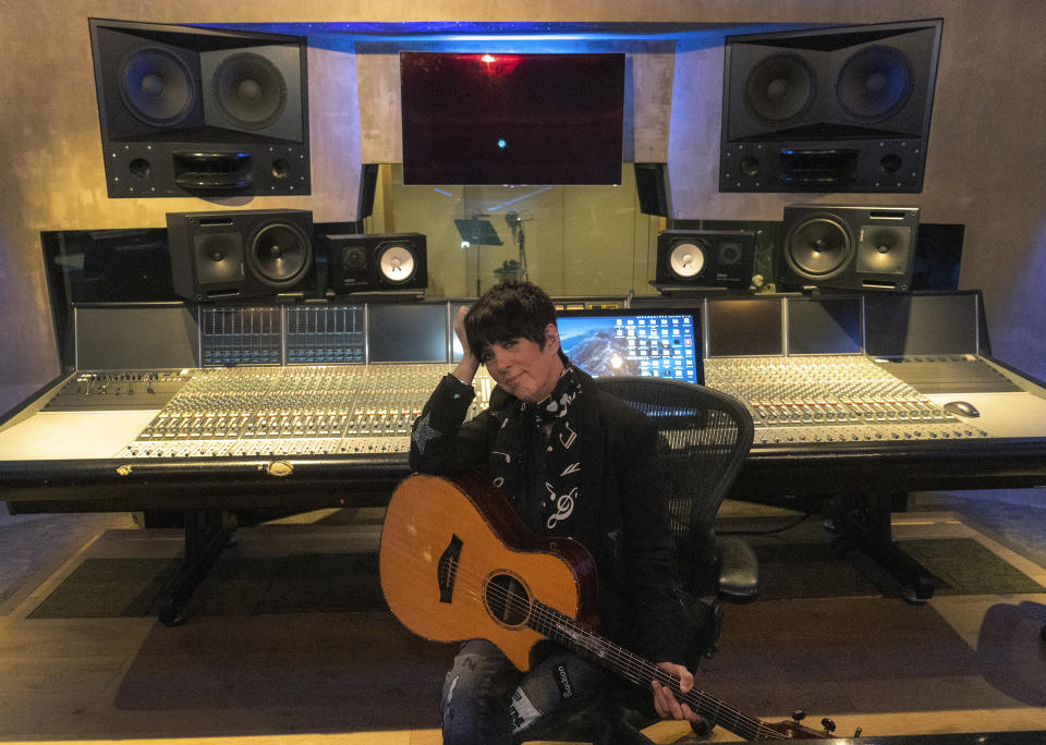 Songwriter Diane Warren poses with her Taylor guitar in her studio at the Realsongs Diane Warren Music Company in Los Angeles, Tuesday, Nov. 15, 2022. Warren will receive an honorary Oscar at the annual Governors Awards. She’s the first songwriter to ever get the award. (AP Photo/Damian Dovarganes)