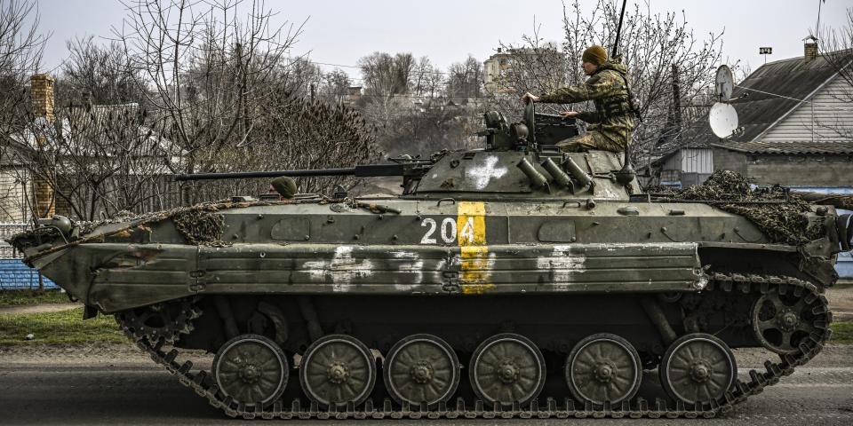 A Ukrainian soldier sits in a tank.