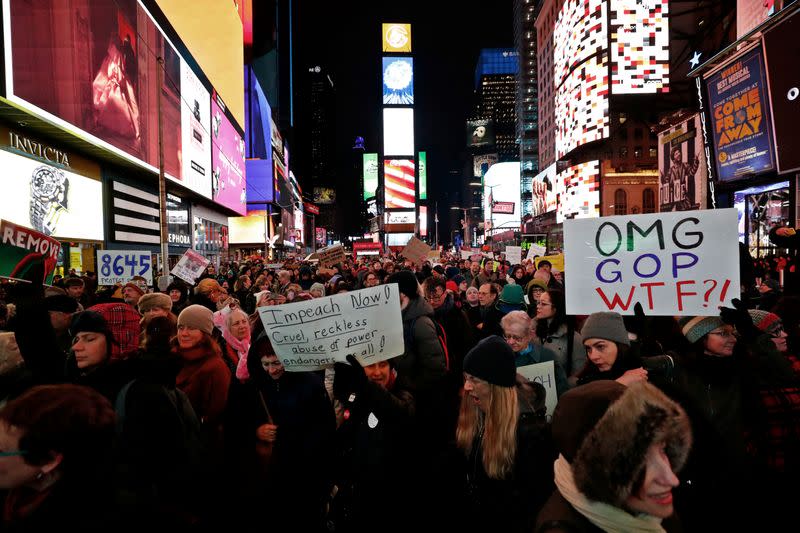 Demonstrators gather to demand the impeachment and removal of U.S. President Donald Trump during a rally at Times Square in New York City