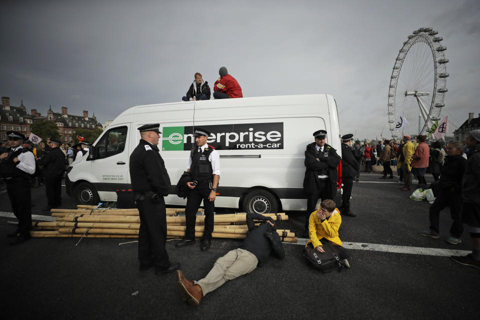 Climate protestors block Westminster bridge, leading to Britain's Parliament, in central London Monday, Oct. 7, 2019, in an attempt to disrupt the heart of government. (AP Photo/Matt Dunham)