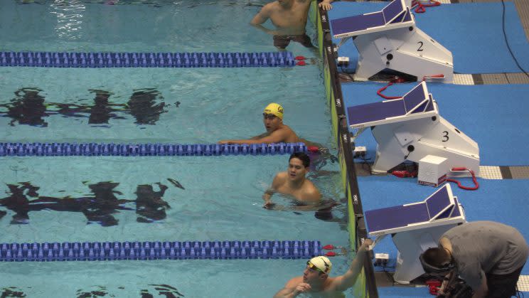 Quah Zheng Wen (in yellow cap) and Joseph Schooling after the 100 yard butterfly at the NCAA swimming championships. Photo: Syahir Ezekiel/The Schooling Effect