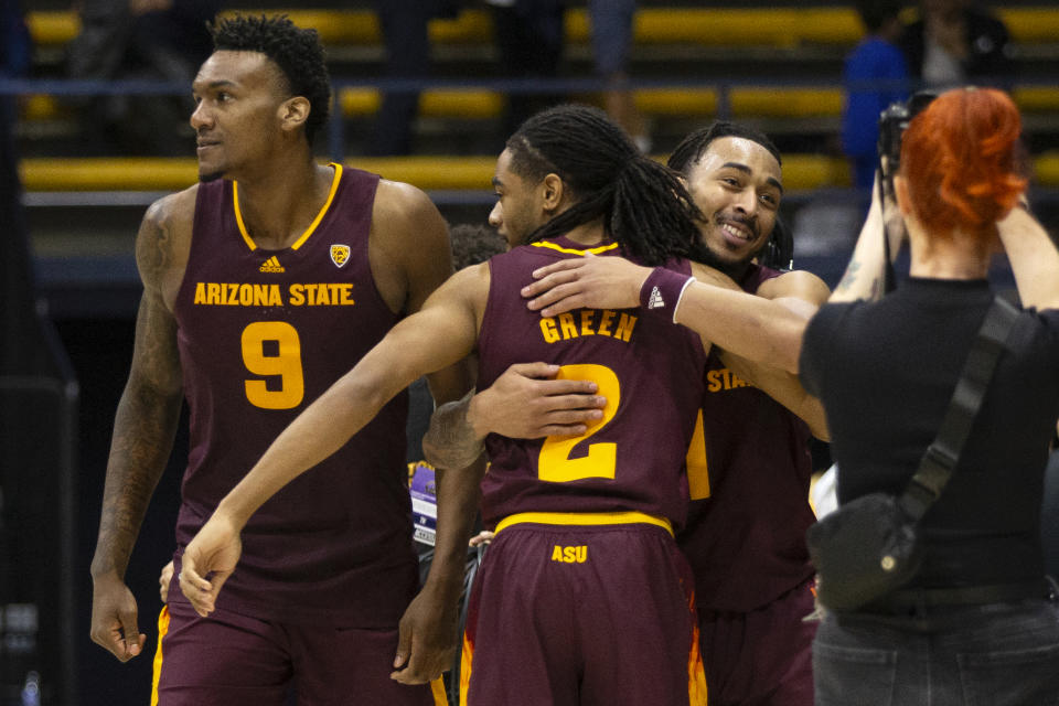 Arizona State teammates Shawn Phillips Jr. (9), Braelon Green (2) and Frankie Collins (1) celebrate after their comeback win over California in an NCAA college basketball game, Sunday, Dec. 31, 2023, in Berkeley, Calif. (AP Photo/D. Ross Cameron)