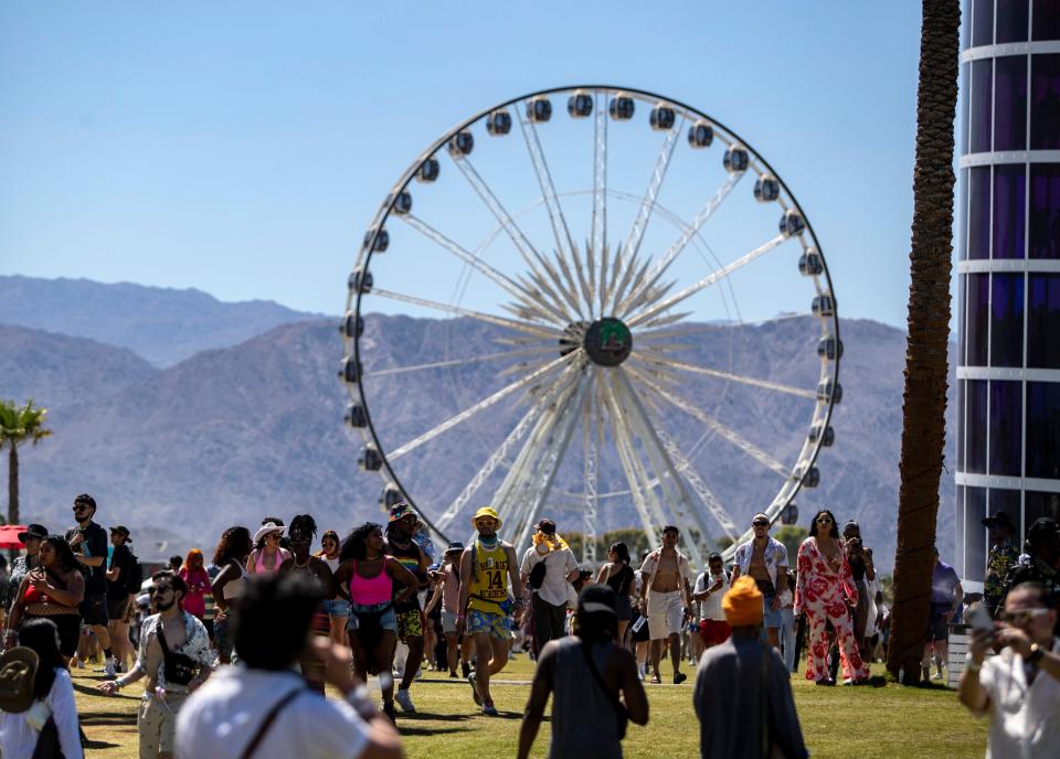 Festivalgoers make their way into the grounds from the main entrance during the Coachella Valley Music and Arts Festival at the Empire Polo Club in Indio, Calif., Friday, April 21, 2023. 