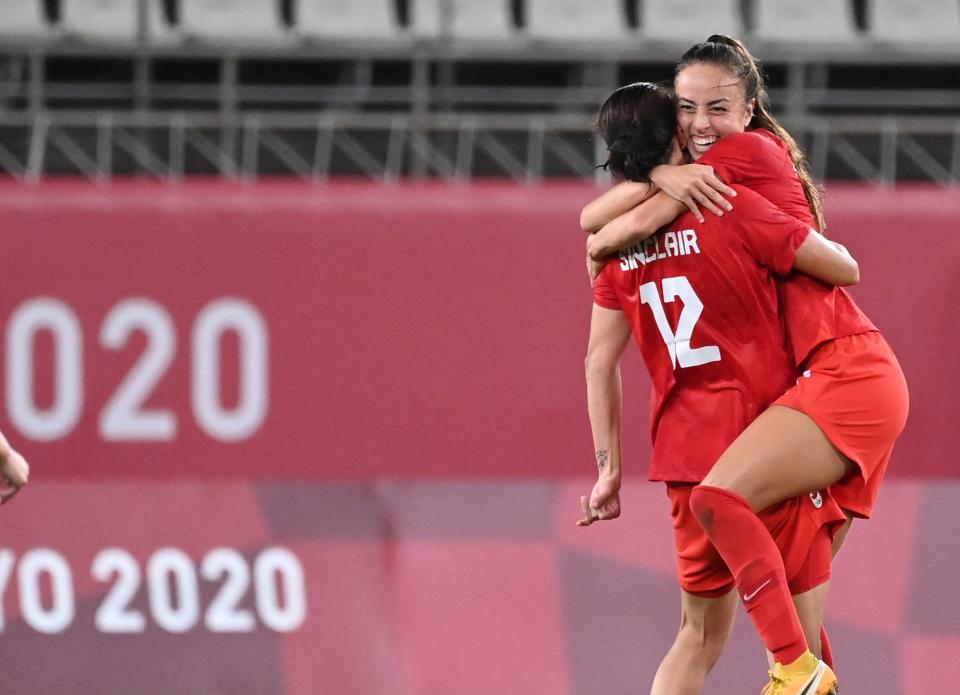 Canada's forward Christine Sinclair celebrates the win with Canada's midfielder Julia Grosso during the Tokyo 2020 Olympic Games women's semi-final football match between the United States and Canada at Ibaraki Kashima Stadium in Kashima on August 2, 2021. (Photo by MARTIN BERNETTI / AFP) (Photo by MARTIN BERNETTI/AFP via Getty Images)