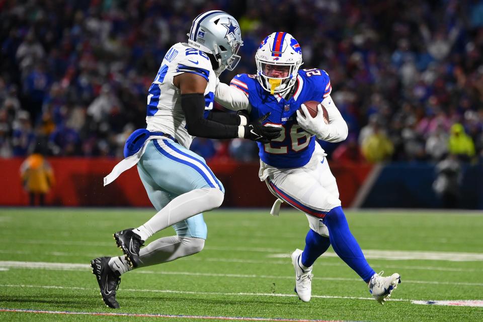 ORCHARD PARK, NEW YORK - DECEMBER 17: Ty Johnson #26 of the Buffalo Bills stiff arms DaRon Bland #26 of the Dallas Cowboys during the third quarter at Highmark Stadium on December 17, 2023 in Orchard Park, New York. (Photo by Rich Barnes/Getty Images)