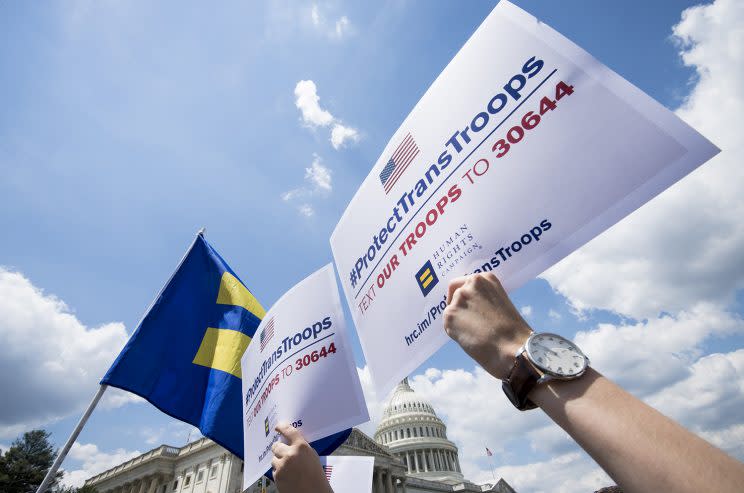 Human Rights Campaign supporters hold up signs outside of the Capitol to call on President Trump to reverse his ban on transgender Americans from serving in the military on July 25.
