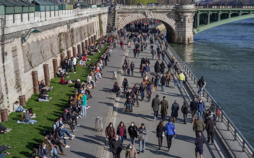 People on the Seine river bank, in Paris, France, on Saturday -  Rafael Yaghobzadeh/ AP