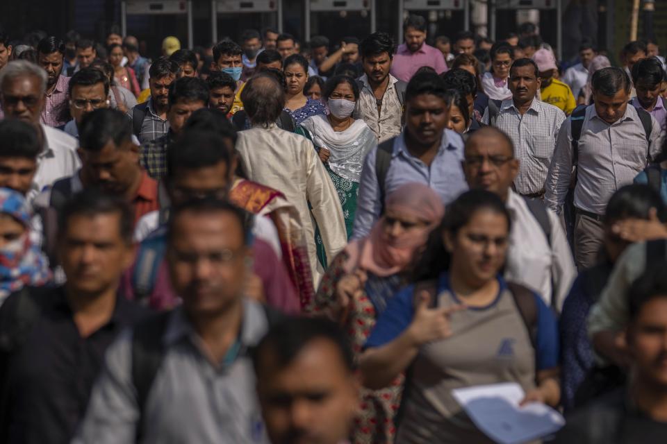 FILE - Indian commuters leave at Chhatrapati Shivaji Maharaj train terminus in Mumbai, India, Monday, Nov. 14, 2022. Demographers are unsure exactly when India will take the title as the most populous nation in the world because they're relying on estimates to make their best guess. (AP Photo/Rafiq Maqbool, File)