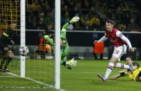 Arsenal's Aaron Ramsey (R)scores a goal past Borussia Dortmund's goalkeeper Roman Weidenfeller during their Champions League Group F soccer match in Dortmund November 6, 2013. REUTERS/Wolfgang Rattay (GERMANY - Tags: SPORT SOCCER TPX IMAGES OF THE DAY)