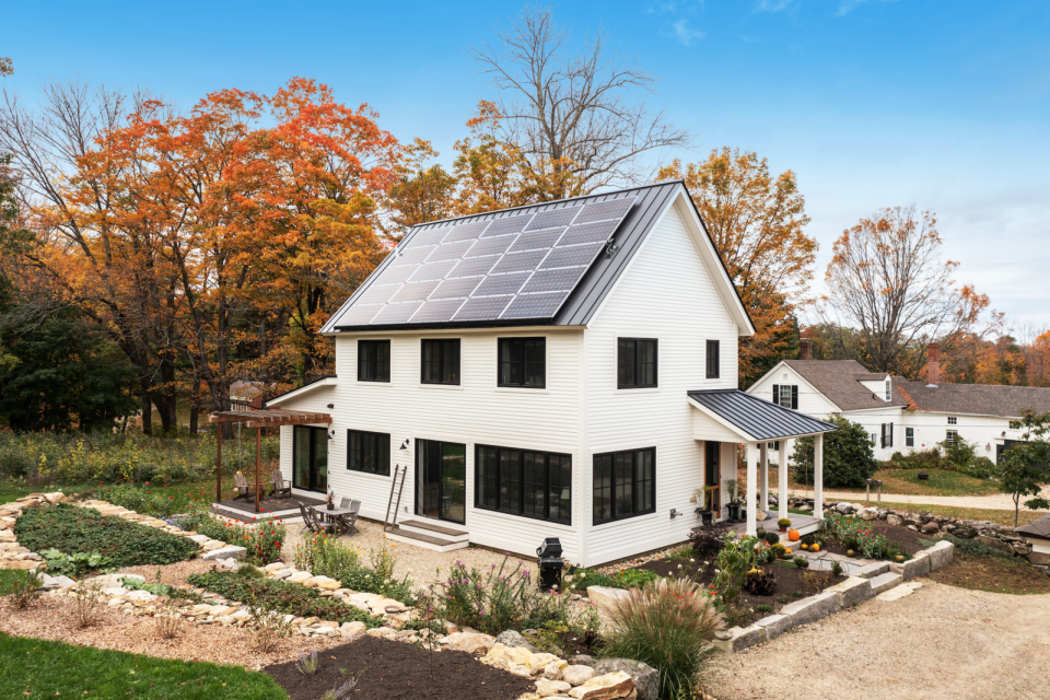 Solar panels facing the sunniest part of the home help heat its water and charge its electricity.