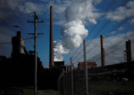 FILE PHOTO: A cloud rises from the Port Kembla steelworks behind an electricity pole in Wollongong, south of Sydney, Australia, February 21, 2017. REUTERS/Jason Reed/File Photo
