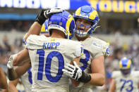 Los Angeles Rams wide receiver Cooper Kupp (10) is hugged after his touchdown catch during the first half of an NFL football game against the Tampa Bay Buccaneers Sunday, Sept. 26, 2021, in Inglewood, Calif. (AP Photo/Kevork Djansezian)