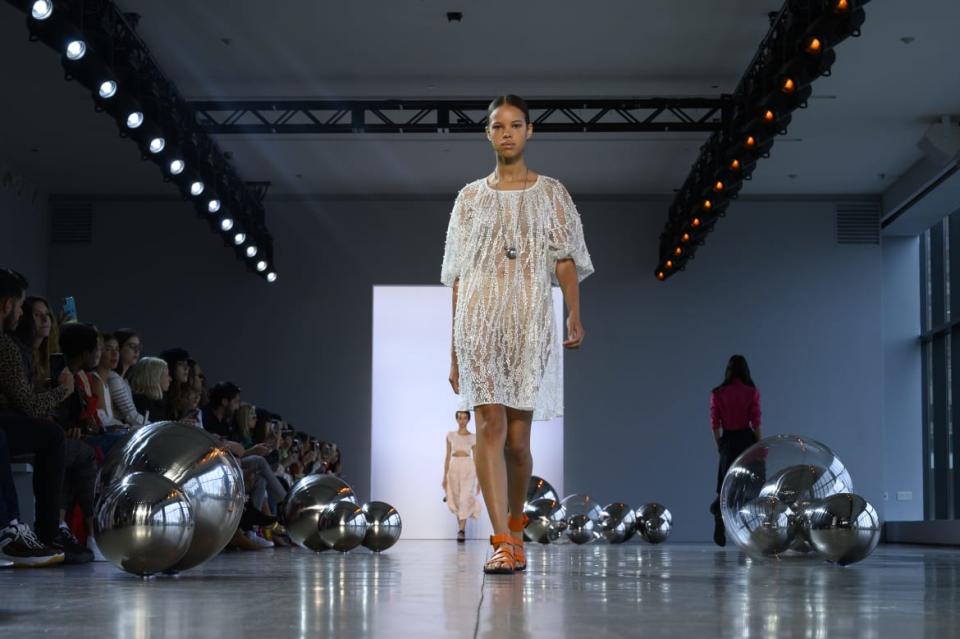 <div class="inline-image__caption"><p>Waistlines were basically absent; instead, dresses floated as models sauntered in between large silver spheres. </p></div> <div class="inline-image__credit">Peter White/Getty</div>