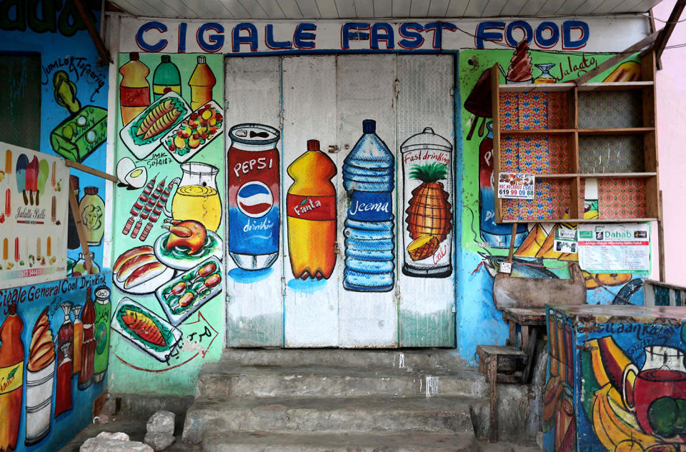 <p>A mural on the wall of a fast food store illustrates food and drinks in Wabari district of Mogadishu, Somalia, June 8, 2017. (Photo: Feisal Omar/Reuters) </p>