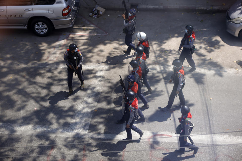 Riot police officers move in to disperse protesters during a demonstration in Yangon, Myanmar, Sunday, March 7, 2021. The escalation of violence in Myanmar as authorities crack down on protests against the Feb. 1 coup is raising pressure for more sanctions against the junta, even as countries struggle over how to best sway military leaders inured to global condemnation. (AP Photo)