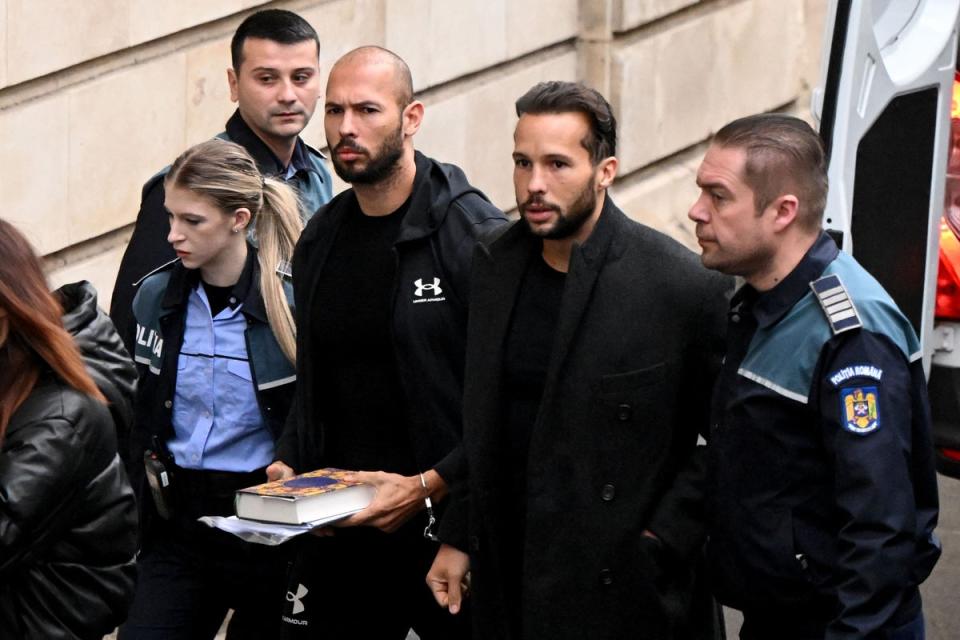 Andrew Tate, 3rd right, and his brother Tristan Tate, 2nd right, arrive at court (AFP via Getty Images)