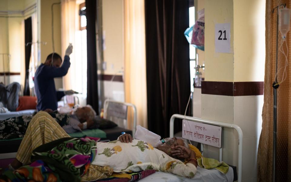 An Indian patient is treated for coronavirus at the Community Health Centre in Jajod, Rajasthan - Rebecca Conway