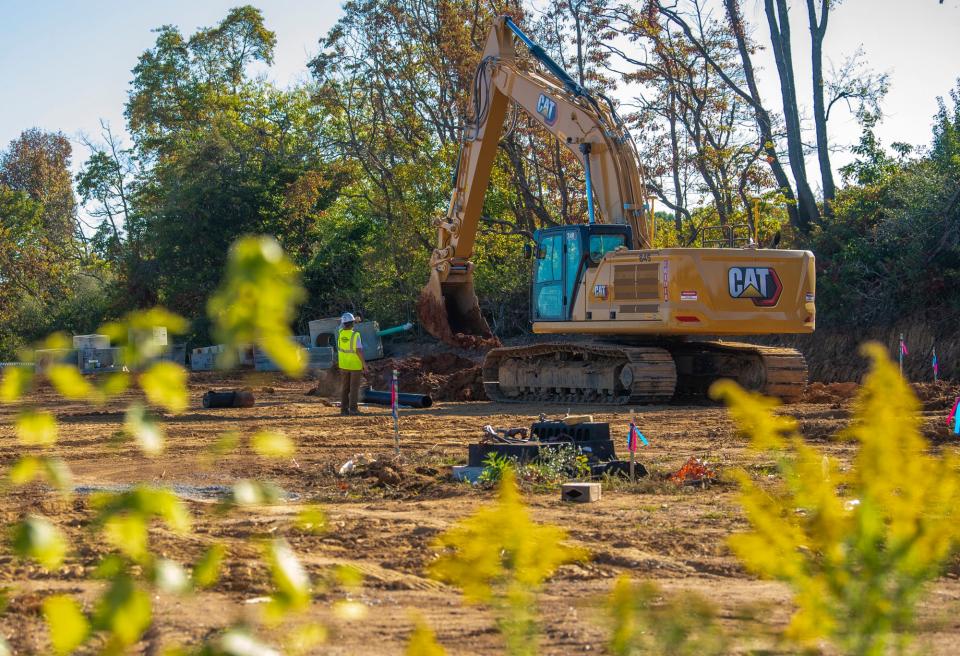 Construction crews dig a trench on a parcel along Liberty Drive that will be a new Kia automobile dealership on Tuesday, Oct. 3, 2024.