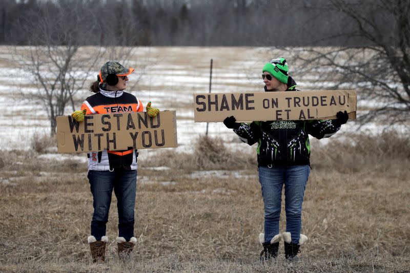 Two women from neighbouring Prince Edward County hold signs in solidarity with the Tyendinage Mohawks, in Tyendinaga