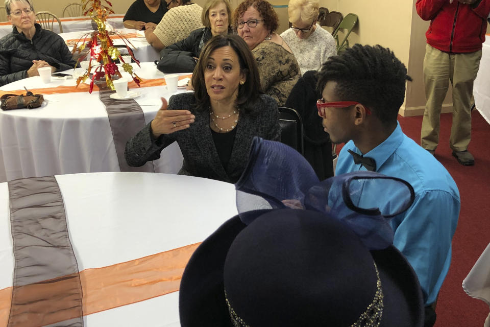 Democratic presidential candidate Sen. Kamala Harris, D-Calif., speaks to DeVon Walker, 17, right, at a church congregation breakfast in Fort Dodge, Iowa, on Nov. 10, 2019. (AP Photo/Kathleen Ronayne)