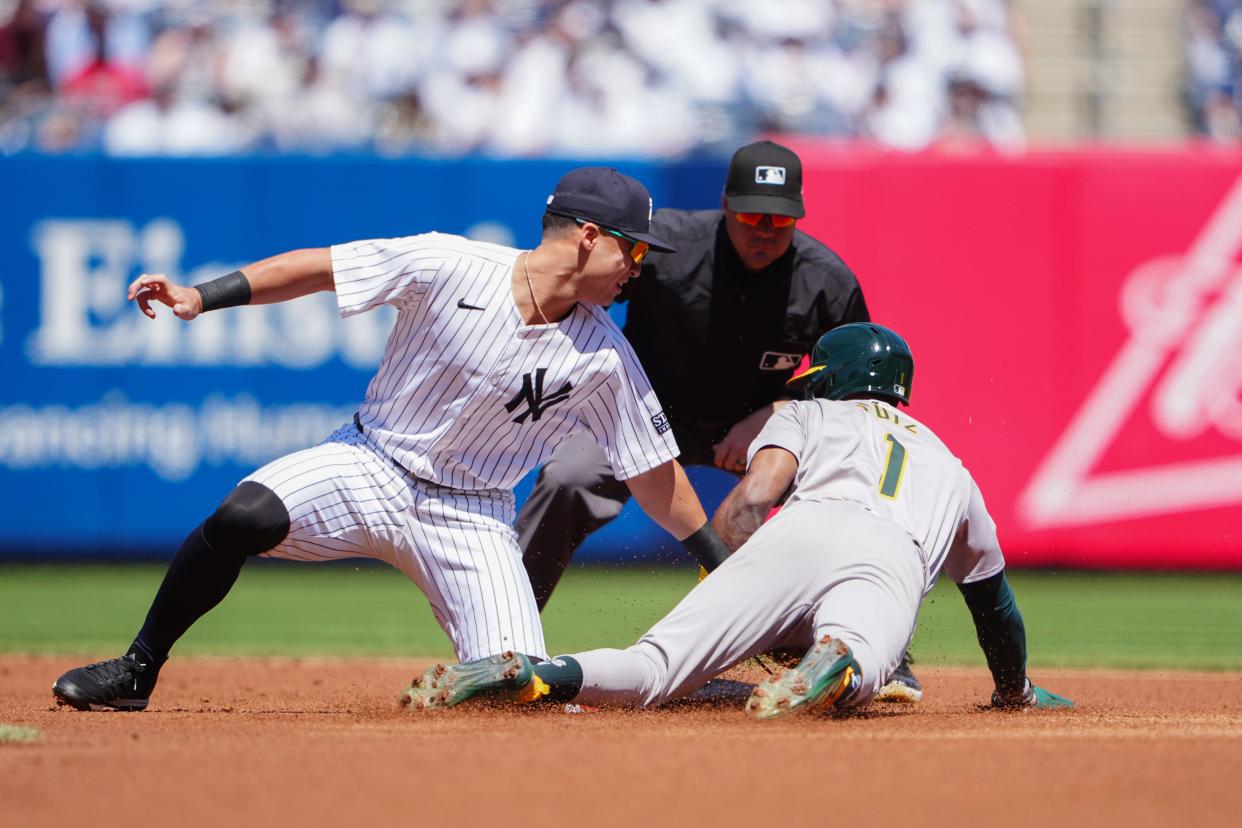 Apr 22, 2024; Bronx, New York, USA; Oakland Athletics left fielder Esteury Ruiz (1) is tagged out while attempting to steal second base against New York Yankees shortstop Anthony Volpe (11) during the first inning at Yankee Stadium. Mandatory Credit: Gregory Fisher-USA TODAY Sports