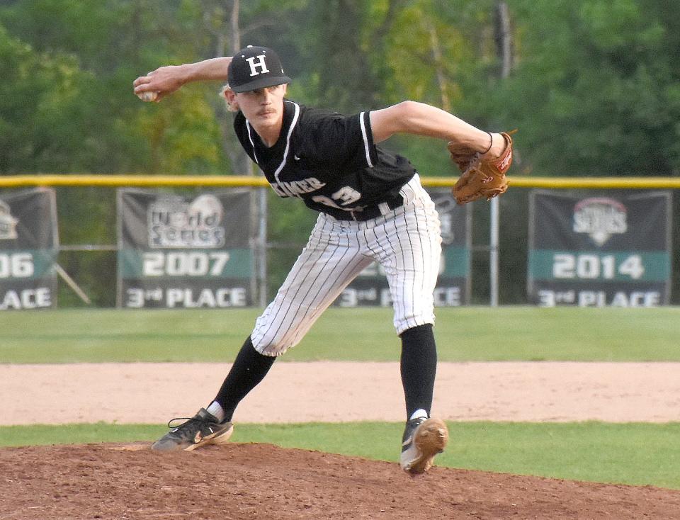 Herkimer College General Eddie Rogers delivers a pitch Saturday in front of banners commemorating the program's previous NJCAA World Series appearances. Rogers and the 2022 Generals will add an eighth banner after they received an at-large bid Tuesday.