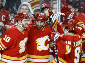 Calgary Flames forward Nazem Kadri (91) celebrates his goal with teammates during the third period of an NHL hockey game against the Arizona Coyotes in Calgary, Alberta, Sunday, April 14, 2024. (Jeff McIntosh/The Canadian Press via AP)