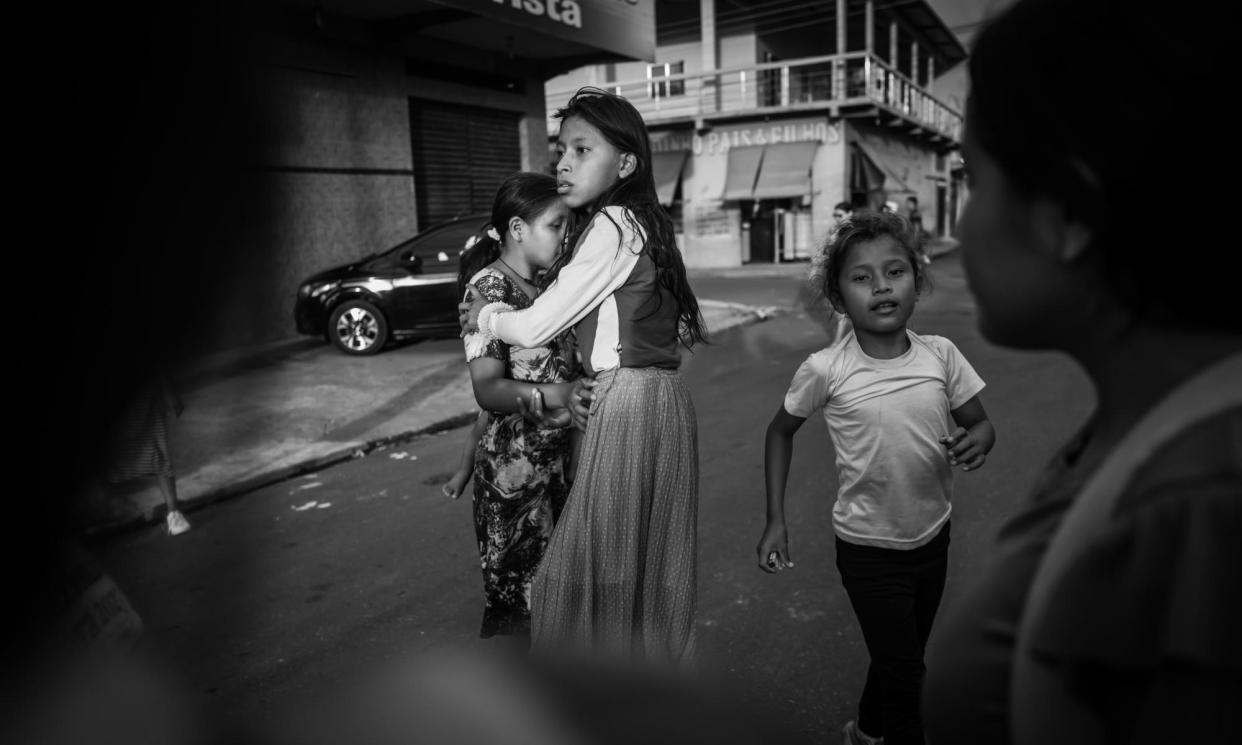 <span>Warao girls on their way home from school in Manaus. The children are adapting fast to their new reality, but some fear traditional knowledge such as weaving, fishing and hunting – and the language and songs that go with those traditions – will be lost. </span><span>Photograph: Nicola Zolin</span>