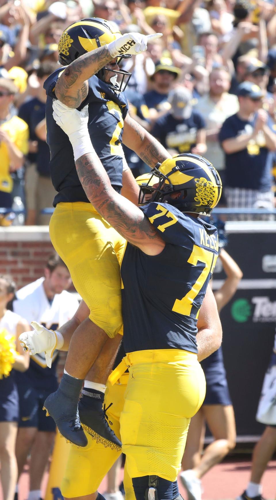 Michigan Wolverines running back Blake Corum (2) celebrates his touchdown against the Colorado State Rams with offensive lineman Trevor Keegan (77) during first half action Saturday, September 3, 2022. 