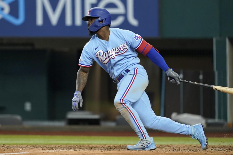 Texas Rangers' Adolis Garcia follows through on a ground out that scored Marcus Semien in the eighth inning of a baseball game in Arlington, Texas, Sunday, Aug. 28, 2022. (AP Photo/Tony Gutierrez)