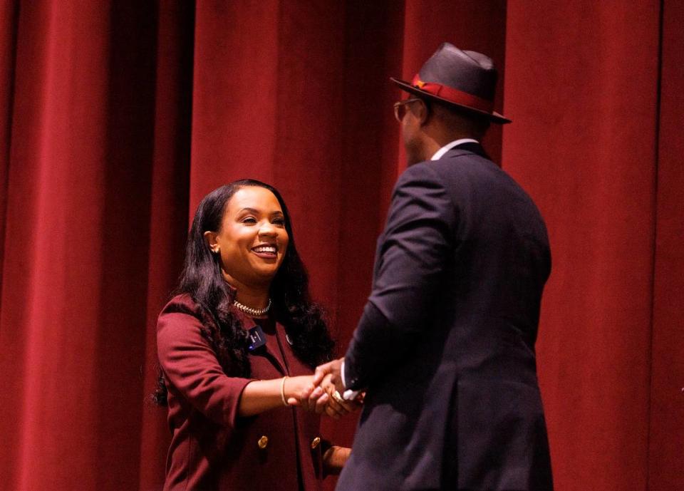 Karrie Dixon shakes hands with Stephen Fusi after being named the new chancellor of North Carolina Central University on Thursday, June 6, 2024, in Durham, N.C.