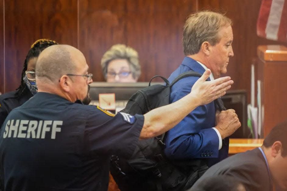 Texas Attorney General Ken Paxton, shown leaving a Houston courtroom last year, is arguing that a comment by the Texas solicitor general during a court hearing Wednesday didn't really mean that the state might have "gone too far" with Senate Bill 4.