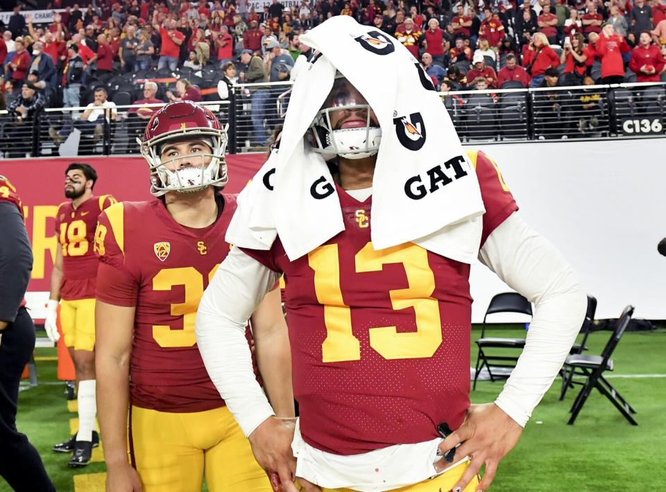 USC quarterback Caleb Williams covers his helmet with a towel.