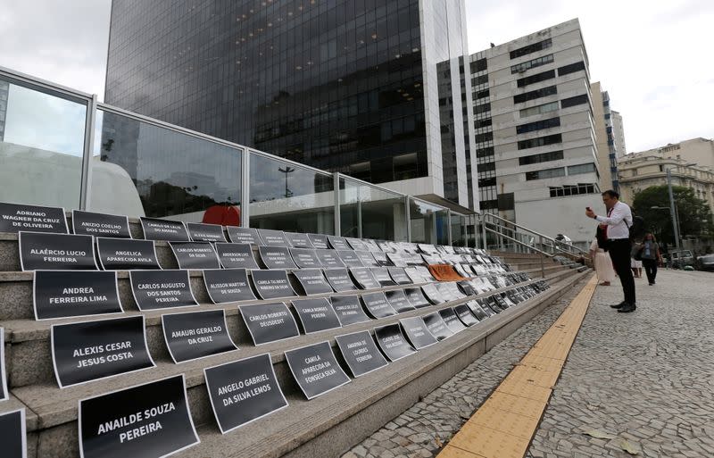 FILE PHOTO: Placards with names of victims of a collapsed tailings dam owned by Vale SA are placed in front of the Brazilian mining company Vale SA bulding, during an assembly of shareholders, in Rio de Janeiro